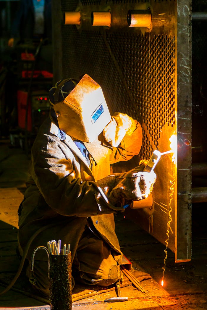 gallery-1 A skilled welder works with a torch in an industrial environment, showcasing metalwork expertise.