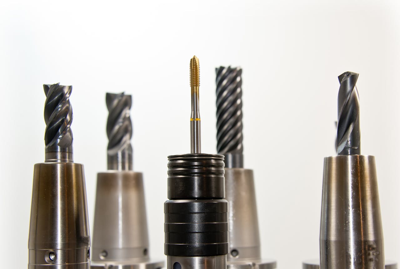 gallery-4 A close-up view of metal drill bits arranged vertically, showcasing industrial tools.